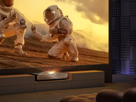 Hisense L9Q ultra-short-throw laser TV projector casting a bright, cinematic 200-inch image in a modern living room.