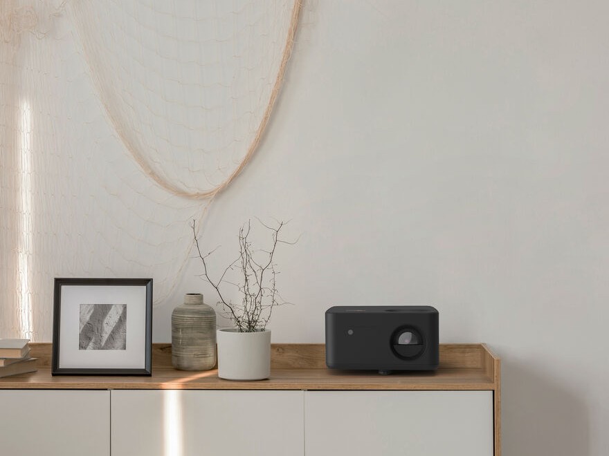 Optoma 4K home projector showcasing cinematic visuals in a modern living room
