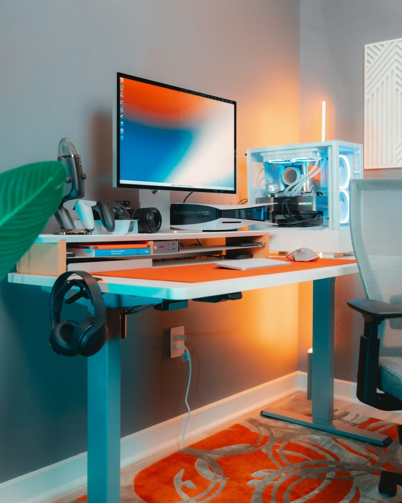 Desk with a computer monitor, keyboard and mouse